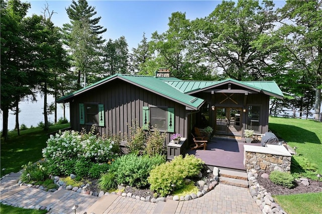 rear view of property with a wooden deck and a yard