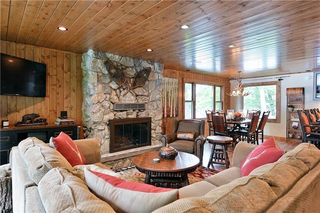 living room with wood ceiling, a fireplace, and wooden walls