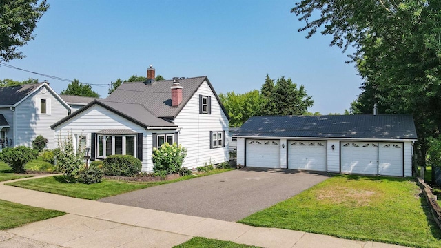 view of front of home with a garage and a front yard