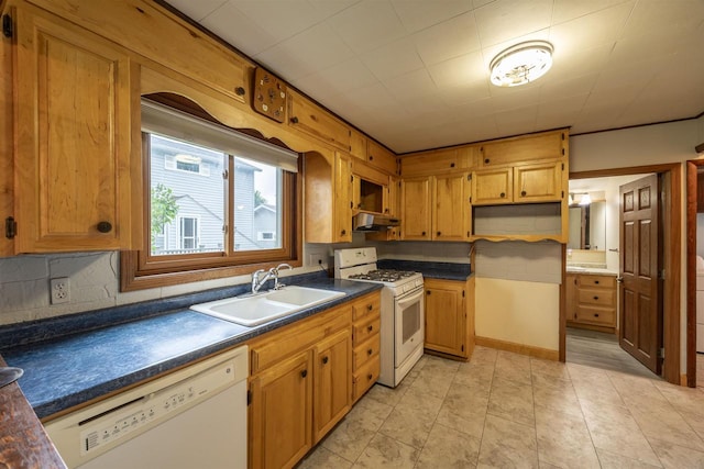 kitchen featuring light tile patterned floors, white appliances, and sink