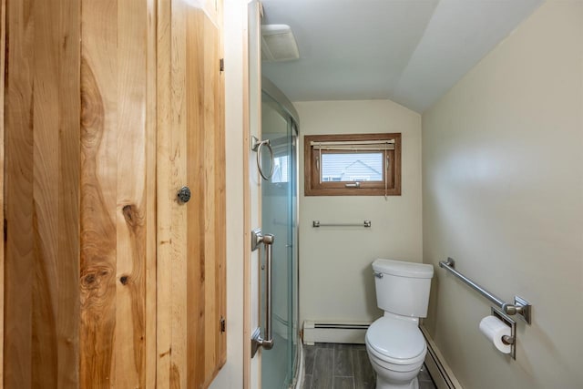 bathroom with toilet, baseboard heating, and lofted ceiling