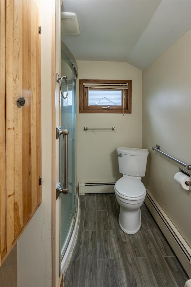 bathroom with toilet, lofted ceiling, a baseboard heating unit, and hardwood / wood-style floors