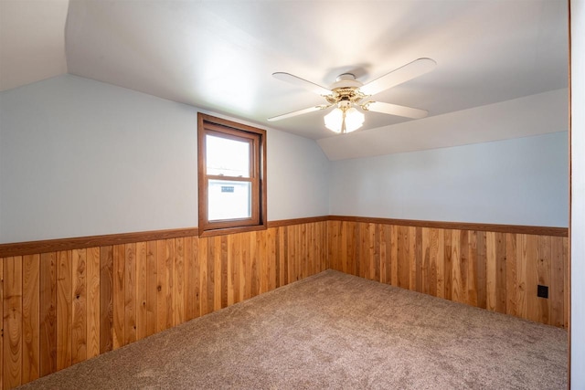 unfurnished room featuring ceiling fan, lofted ceiling, and carpet flooring