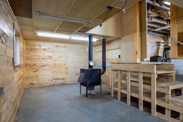 basement featuring wood walls