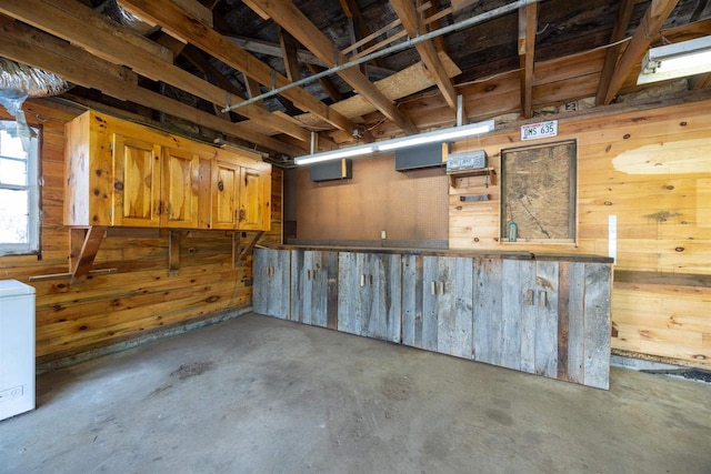 basement with washer / dryer and wooden walls