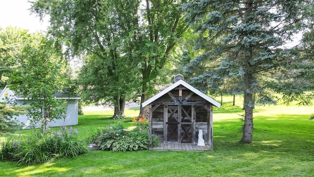 view of outdoor structure featuring a lawn