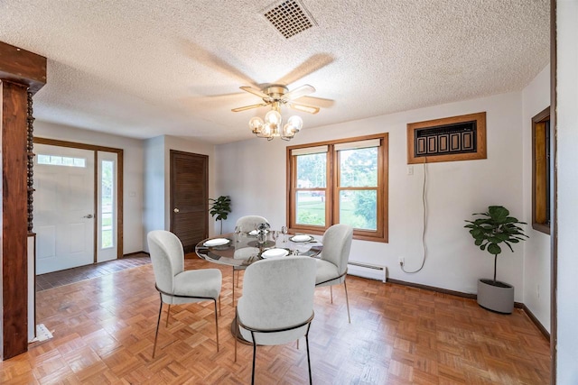 dining room with parquet floors, a baseboard radiator, and a textured ceiling