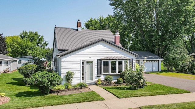 view of front of home featuring a garage and a front lawn