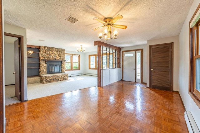 unfurnished living room with carpet, a baseboard radiator, and a textured ceiling