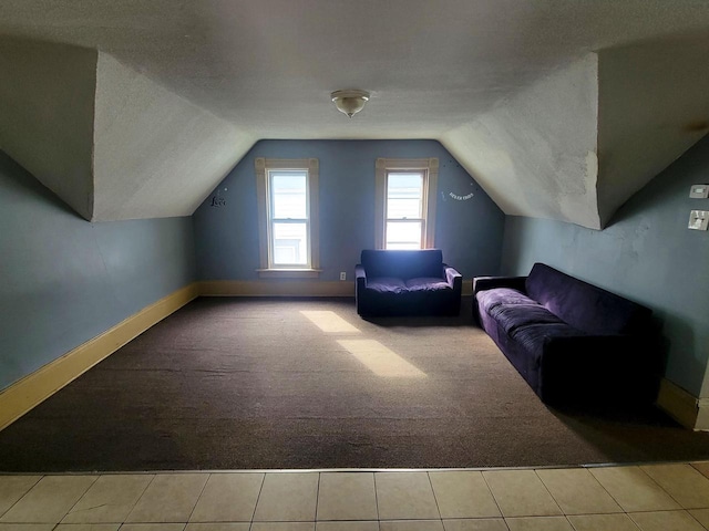 bonus room with light colored carpet, lofted ceiling, and a textured ceiling