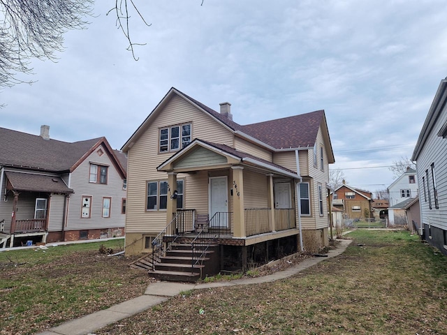 bungalow-style house with a porch and a front yard