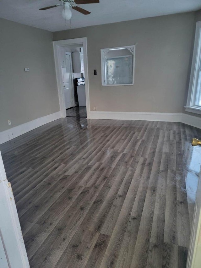 unfurnished living room with dark hardwood / wood-style flooring and ceiling fan