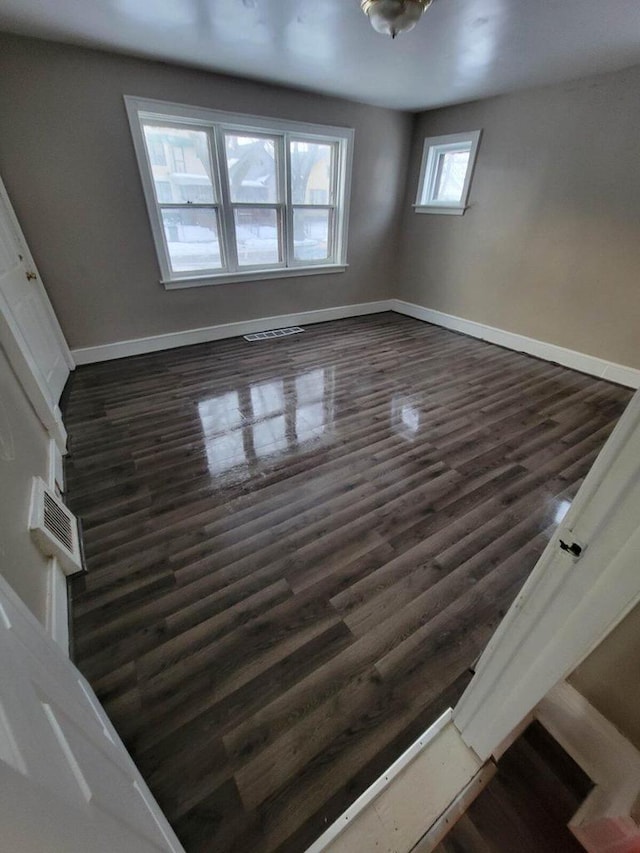 spare room with dark hardwood / wood-style floors