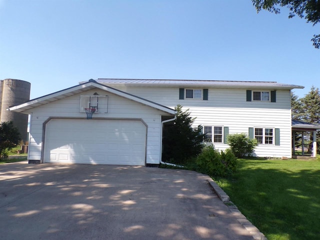 view of front of house with a front yard and a garage