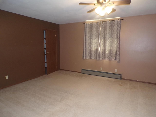 spare room featuring light carpet, ceiling fan, and baseboard heating