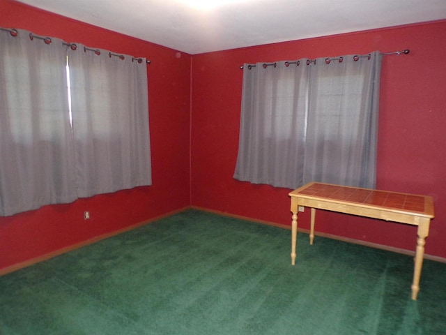 miscellaneous room with dark colored carpet