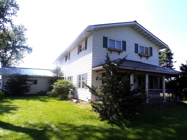 view of front of home featuring a front yard and a porch