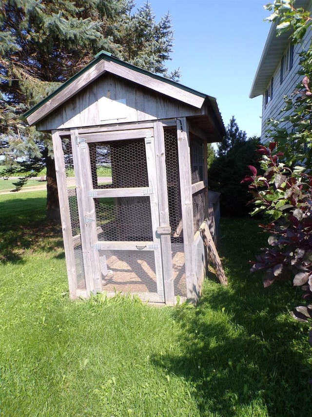 view of outbuilding with a lawn