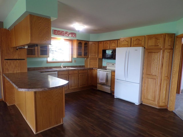 kitchen with dark wood-type flooring, sink, and white appliances