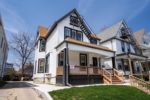 victorian house featuring a porch