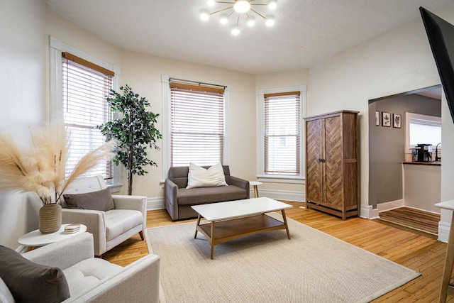 living room featuring hardwood / wood-style flooring and a chandelier