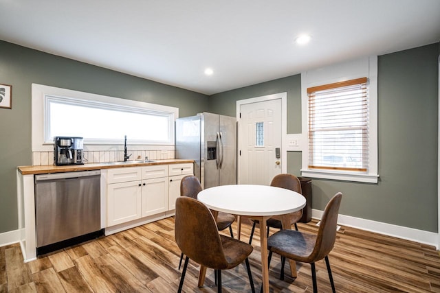 dining room featuring sink and light hardwood / wood-style floors