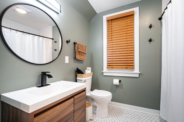 bathroom with vanity, toilet, and tile patterned flooring