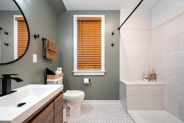 bathroom with vanity, tile patterned floors, a shower, and toilet