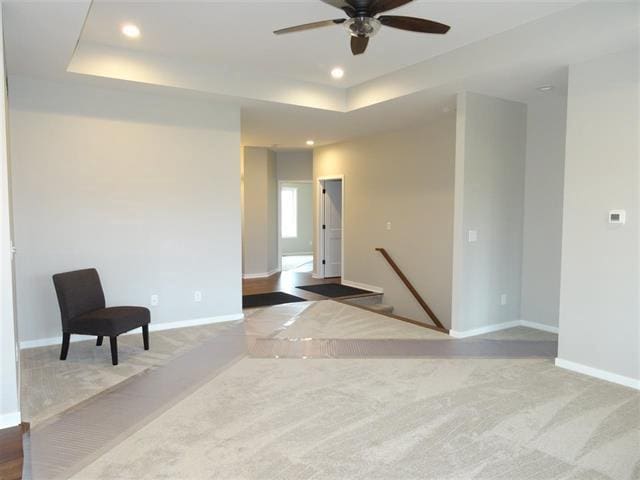 carpeted empty room with a tray ceiling