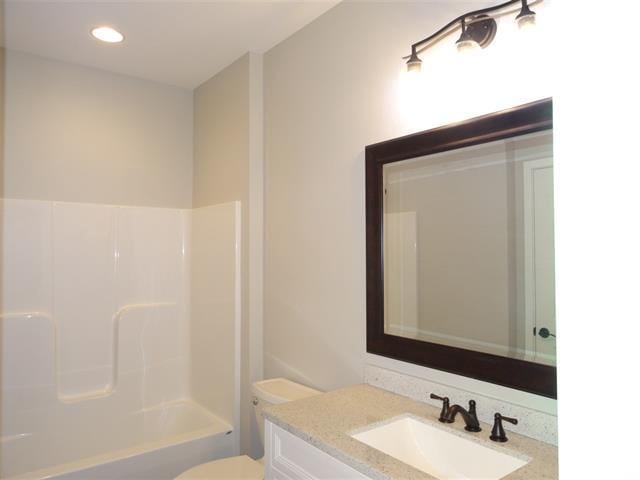 full bathroom with vanity, tub / shower combination, and toilet