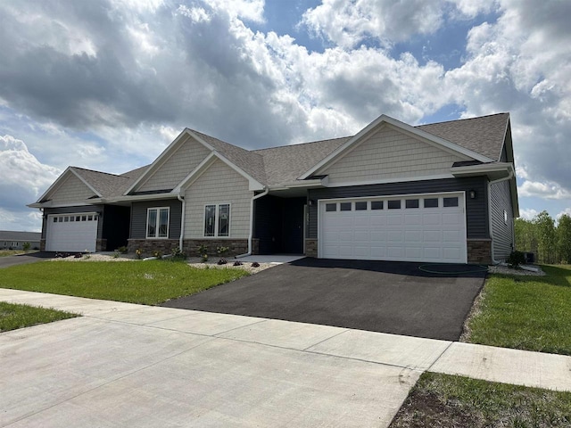 craftsman-style home with a garage and a front lawn