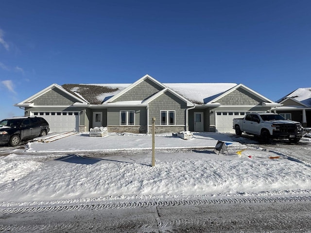 view of front of home featuring a garage and stone siding