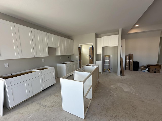 kitchen featuring recessed lighting, white cabinets, and a center island