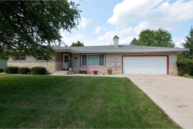 single story home with a garage and a front lawn