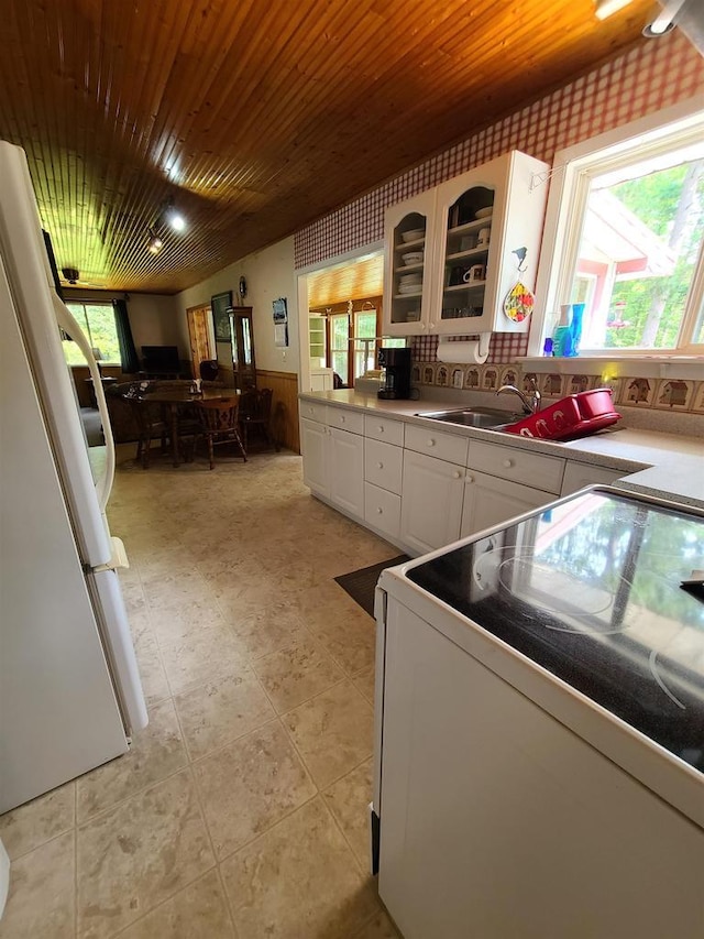 kitchen featuring white cabinetry, white appliances, sink, and wooden ceiling