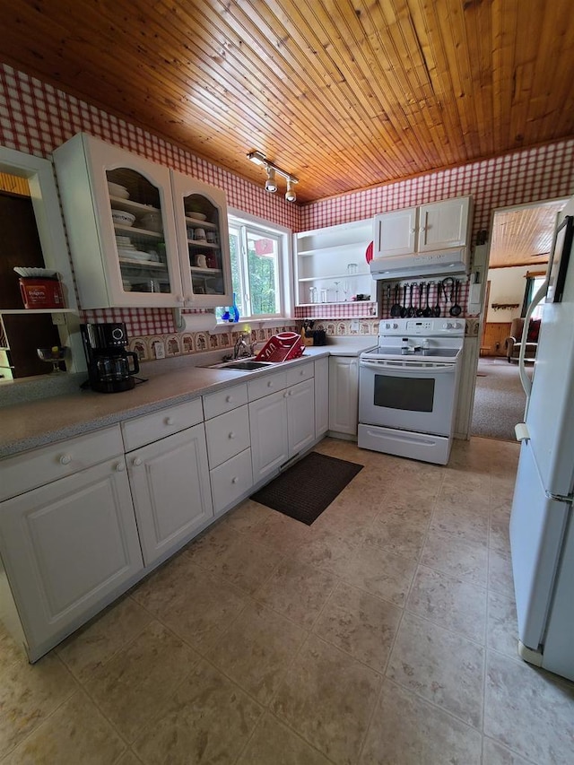 kitchen with white appliances, wooden ceiling, sink, and white cabinets