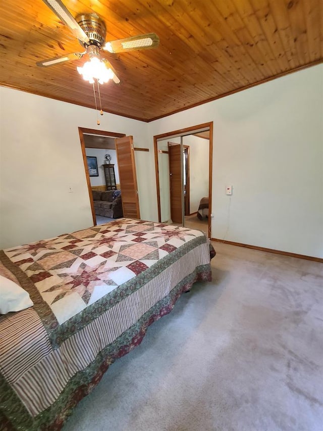 carpeted bedroom with crown molding, wood ceiling, a closet, and ceiling fan