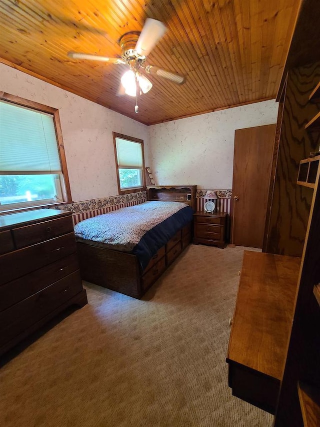 bedroom featuring wooden ceiling, ceiling fan, and carpet