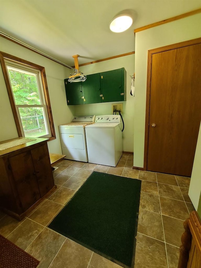 laundry room with cabinets, separate washer and dryer, and dark tile patterned floors