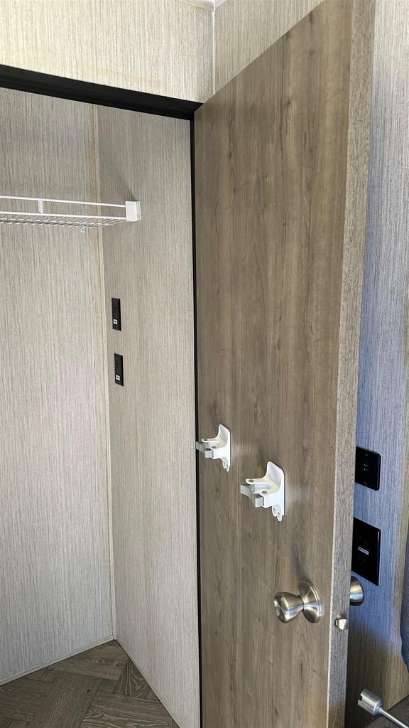laundry area featuring dark parquet flooring