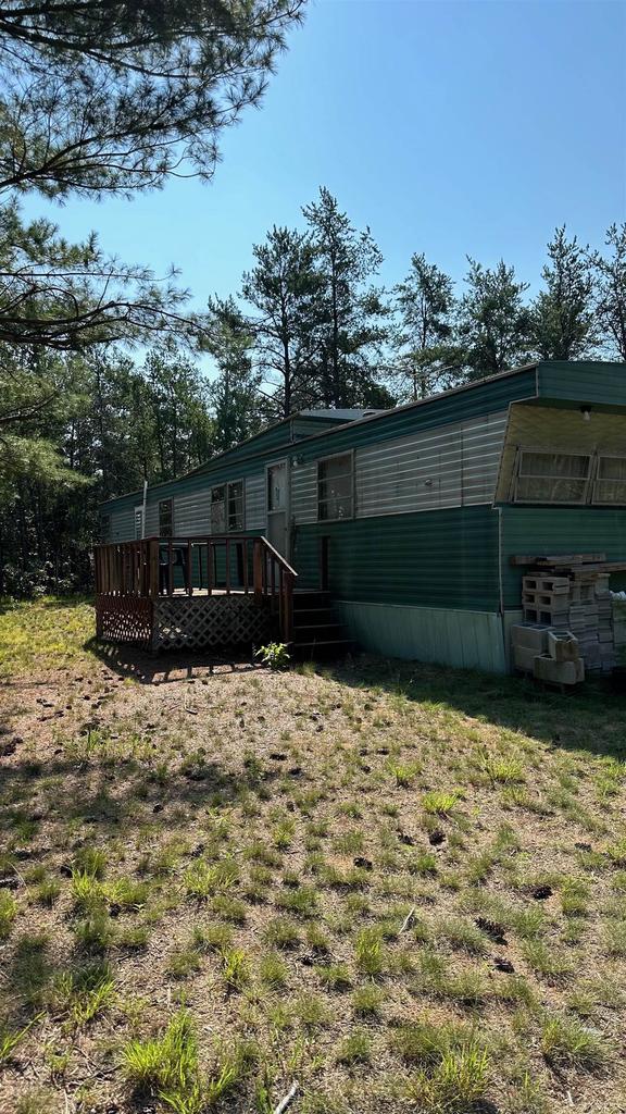 back of property featuring a deck