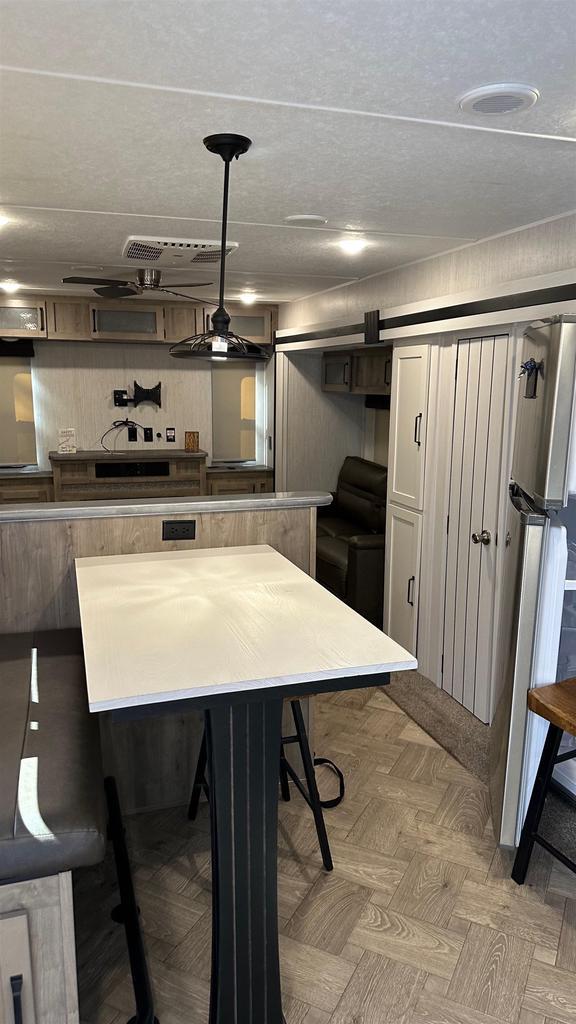kitchen featuring white cabinetry, a breakfast bar area, and decorative light fixtures