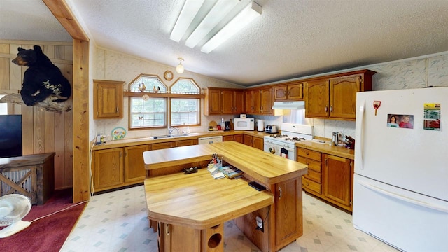 20649 Julia Rd, Clifton, WI 54618 - kitchen featuring white appliances, lofted ceiling, a center island, and a textured ceiling
