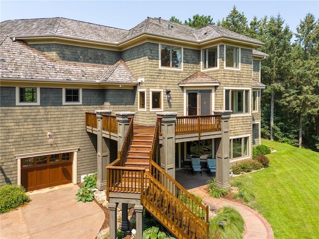 view of front facade with a garage, a deck, and a front yard