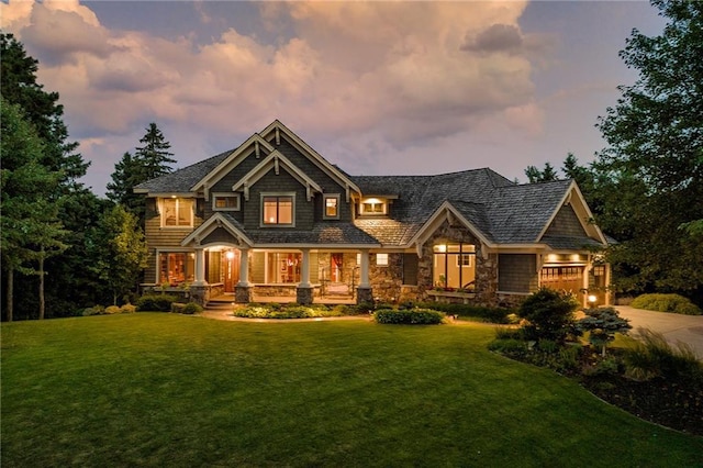 craftsman-style home featuring a yard and covered porch