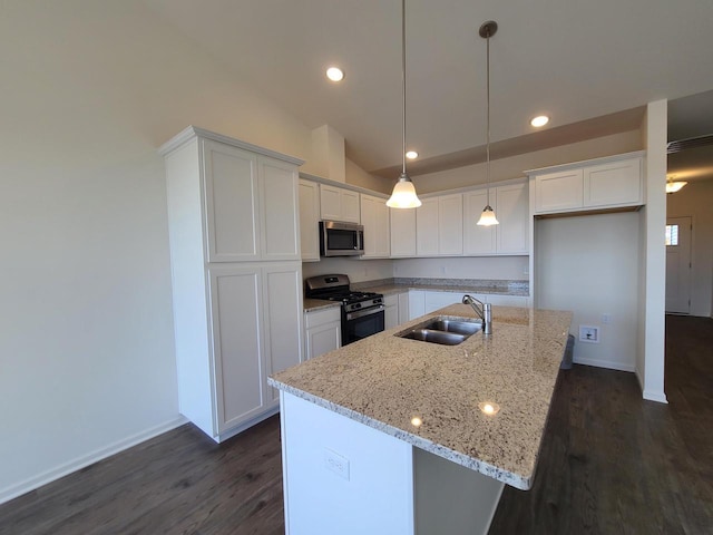 kitchen featuring white cabinetry, stainless steel appliances, sink, and a center island with sink