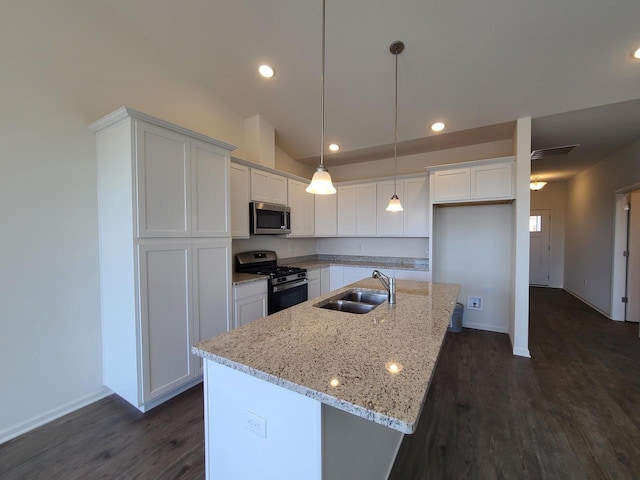 kitchen featuring white cabinetry, appliances with stainless steel finishes, sink, and a center island with sink