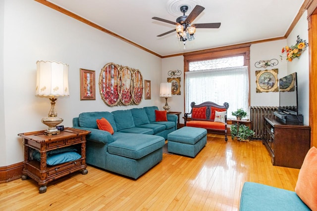 living room with hardwood / wood-style flooring, crown molding, radiator, and ceiling fan