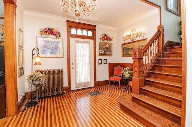 foyer featuring an inviting chandelier, ornamental molding, and radiator