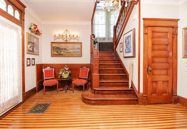 interior space featuring crown molding and a notable chandelier